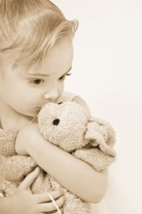 girl cuddling teddy